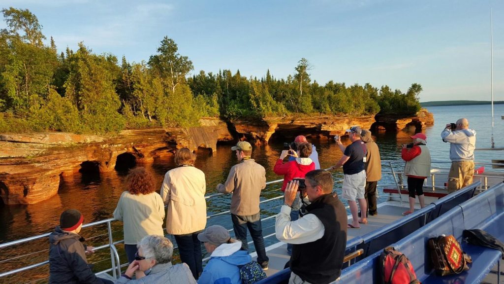 Photographers taking pictures of Devils Island from the top deck of an Apostle Island Cruise.