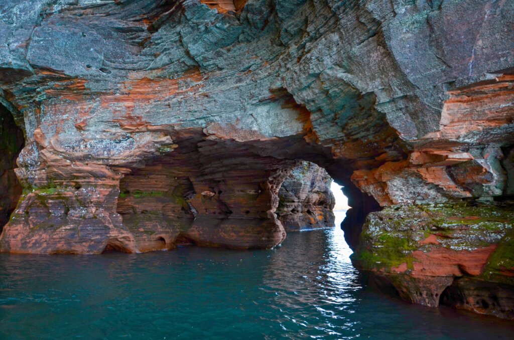 Blue and red colored Sea Caves as seen from an Apostle Islands Cruises tour