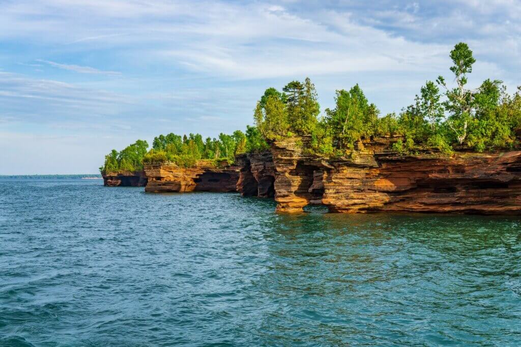 Lake Superior shoreline with caves and forests.