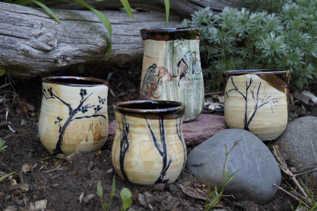 Neutral colored pottery in the forest.