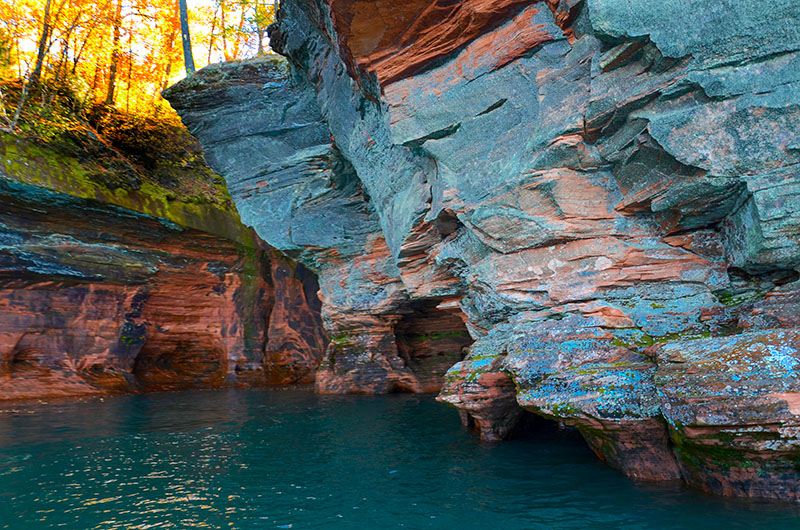 Bright blue and red sandstone cliffs in Apostle Island National Lakeshore.