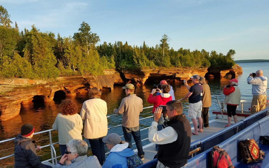 Photographers taking pictures of Devils Island from the top deck of an Apostle Island Cruise.