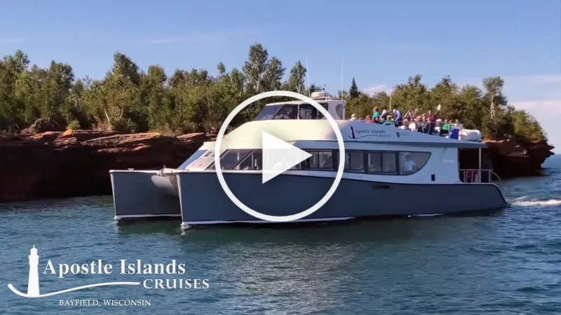 A video preview of an Apostle Islands Cruise, with a play icon overlay.