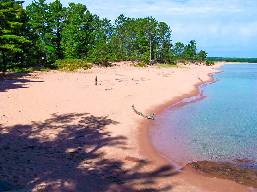 Julian Bay hiking trail on Stockton Island, which features a sandy Lake Superior beach enclosed by forest.