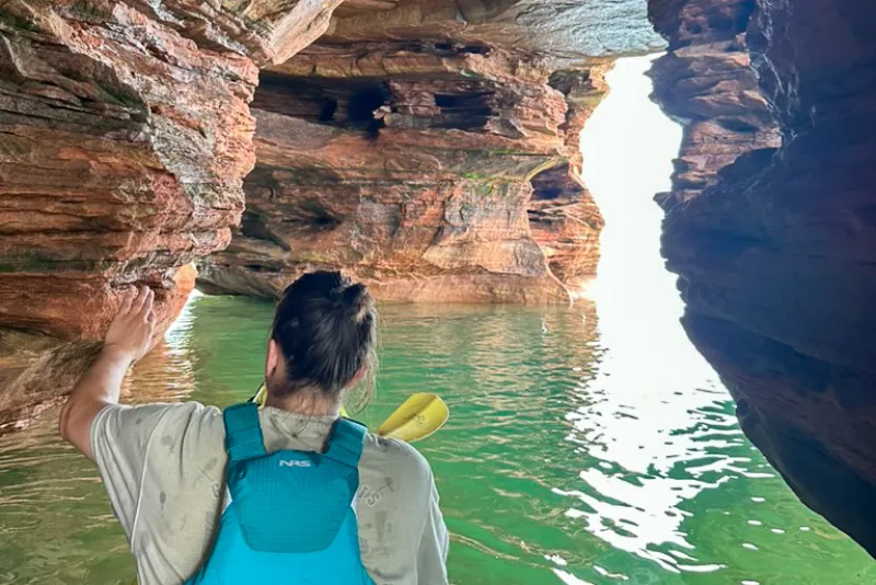 A kayaker exploring the intricate caves of Apostle Islands' Devils Island